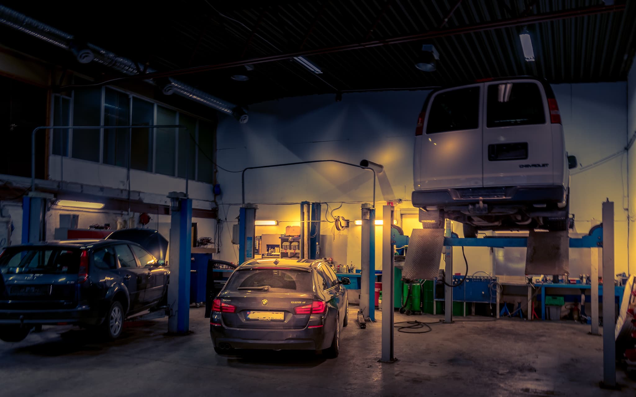 Bil på løftebukk i verkstedhallen